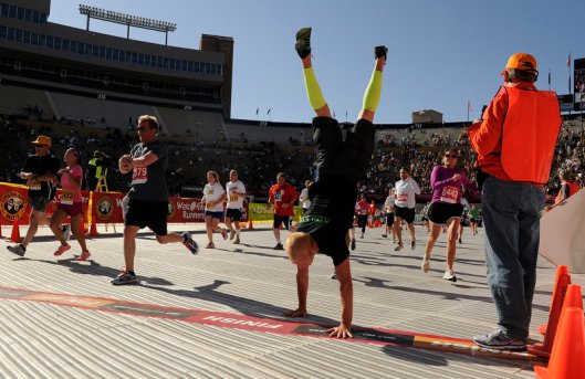 Guys handstands at finish of 2012 Bolder Boulder